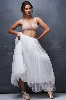 Buy stock photo Portrait of a beautiful young woman posing with a ballet skirt in studio