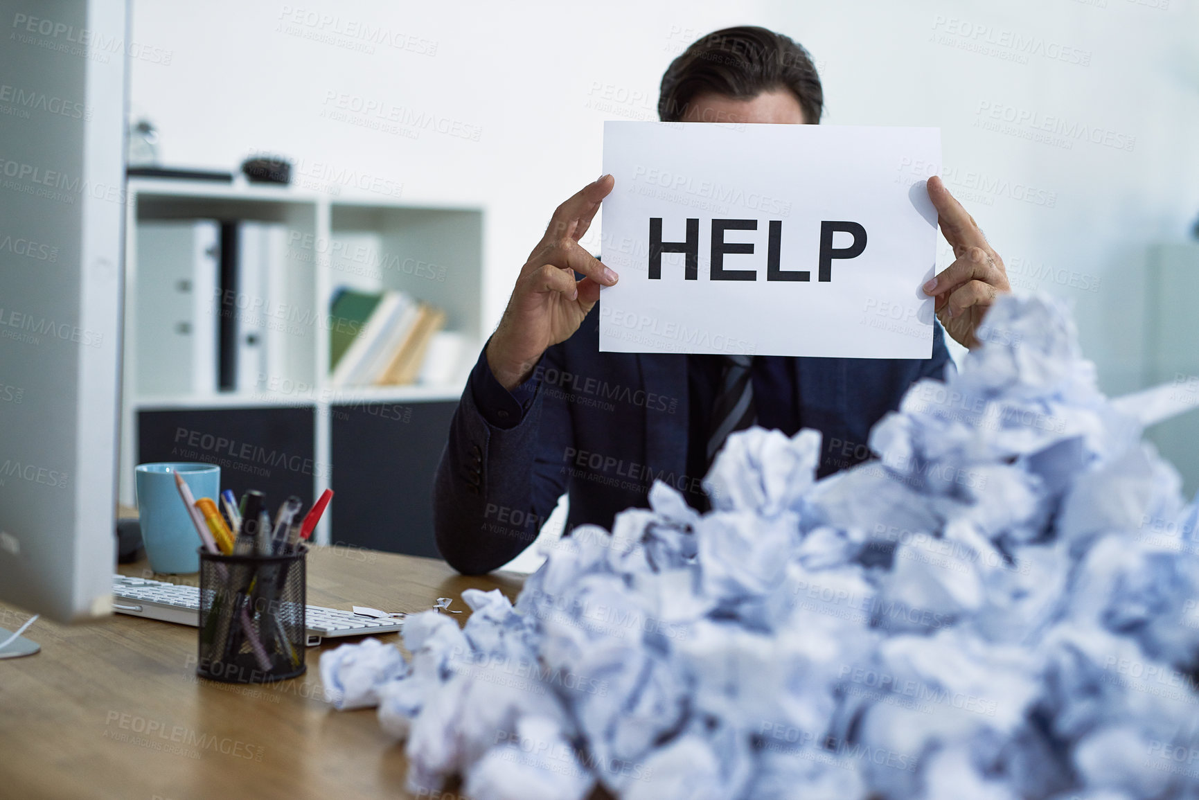 Buy stock photo Help, man and overwhelmed by paperwork, deadline and project as administrator in office with sign. Male person, stress and anxiety with burnout, exhausted and tired as professional at job for company
