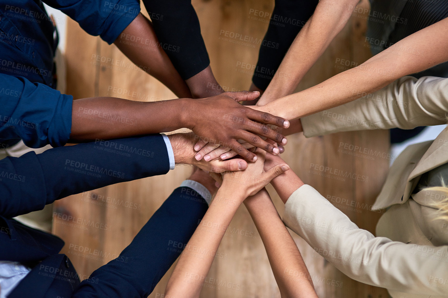 Buy stock photo High angle shot of a group of unidentifiable businesspeople piling their hands in unity in the office