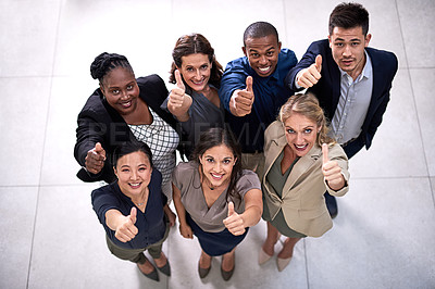 Buy stock photo High angle portrait of a team of businesspeople showing a thumbs up together in the office