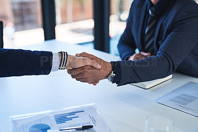Buy stock photo Closeup shot of two businessmen shaking hands in an office