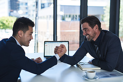 Buy stock photo Cropped shot of two businessmen arm wrestling in an office