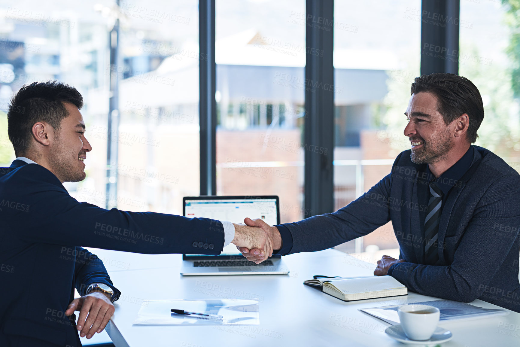 Buy stock photo Business people, laptop and handshake in office for agreement, partnership and collaboration. Tech company, shaking hands and hiring with welcome for acquisition, merger and cybersecurity contract
