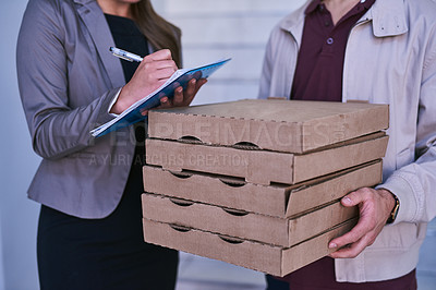 Buy stock photo Cropped shot of a man making a pizza delivery to a businesswoman at work