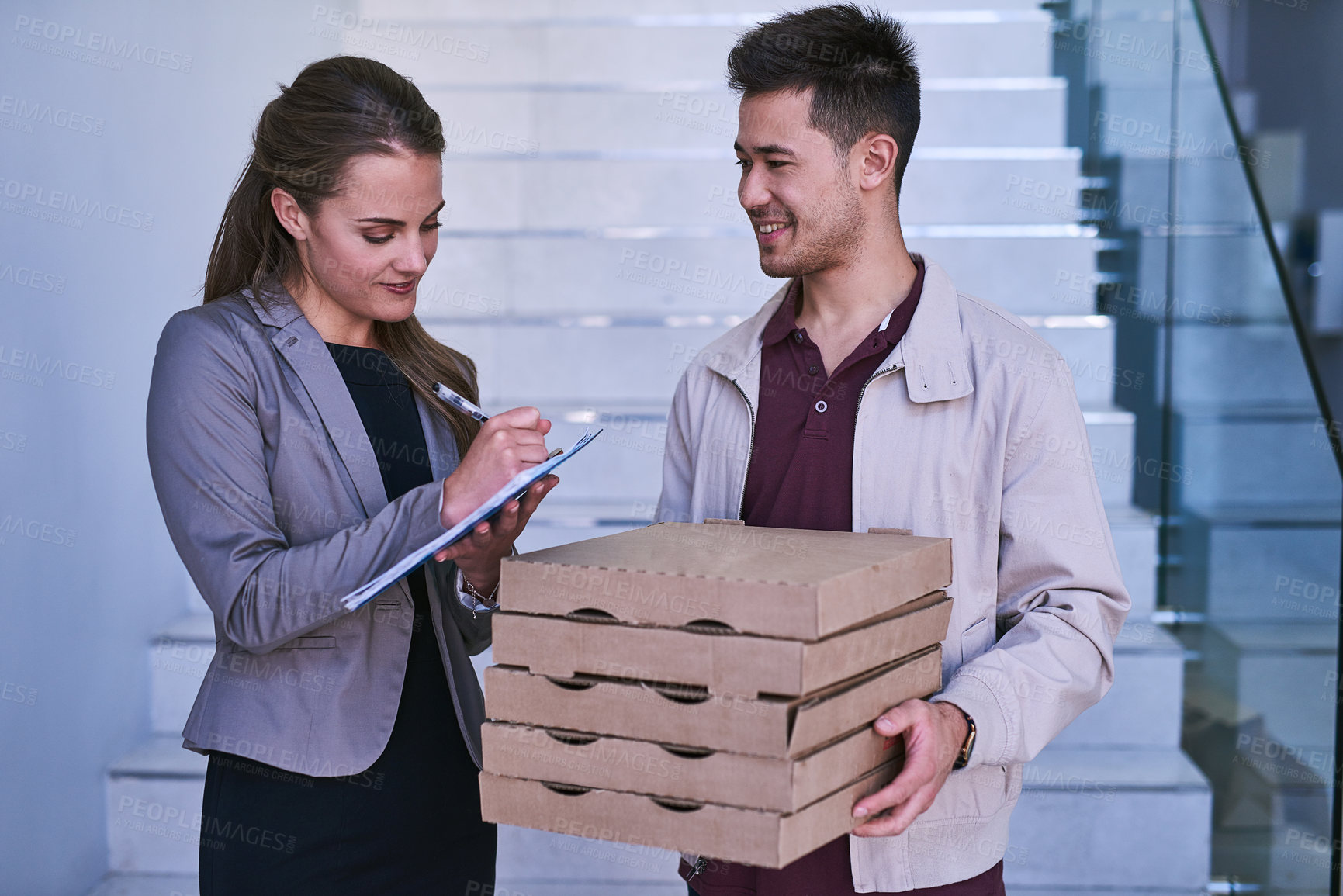 Buy stock photo Business woman, fast food and deliveryman in office with document for signature for compliance. Smile, paperwork and female person signing with courier worker for pizza order for team in workplace.