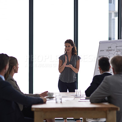 Buy stock photo Cropped shot of a businesswoman giving a presentation to her colleagues in a boardroom