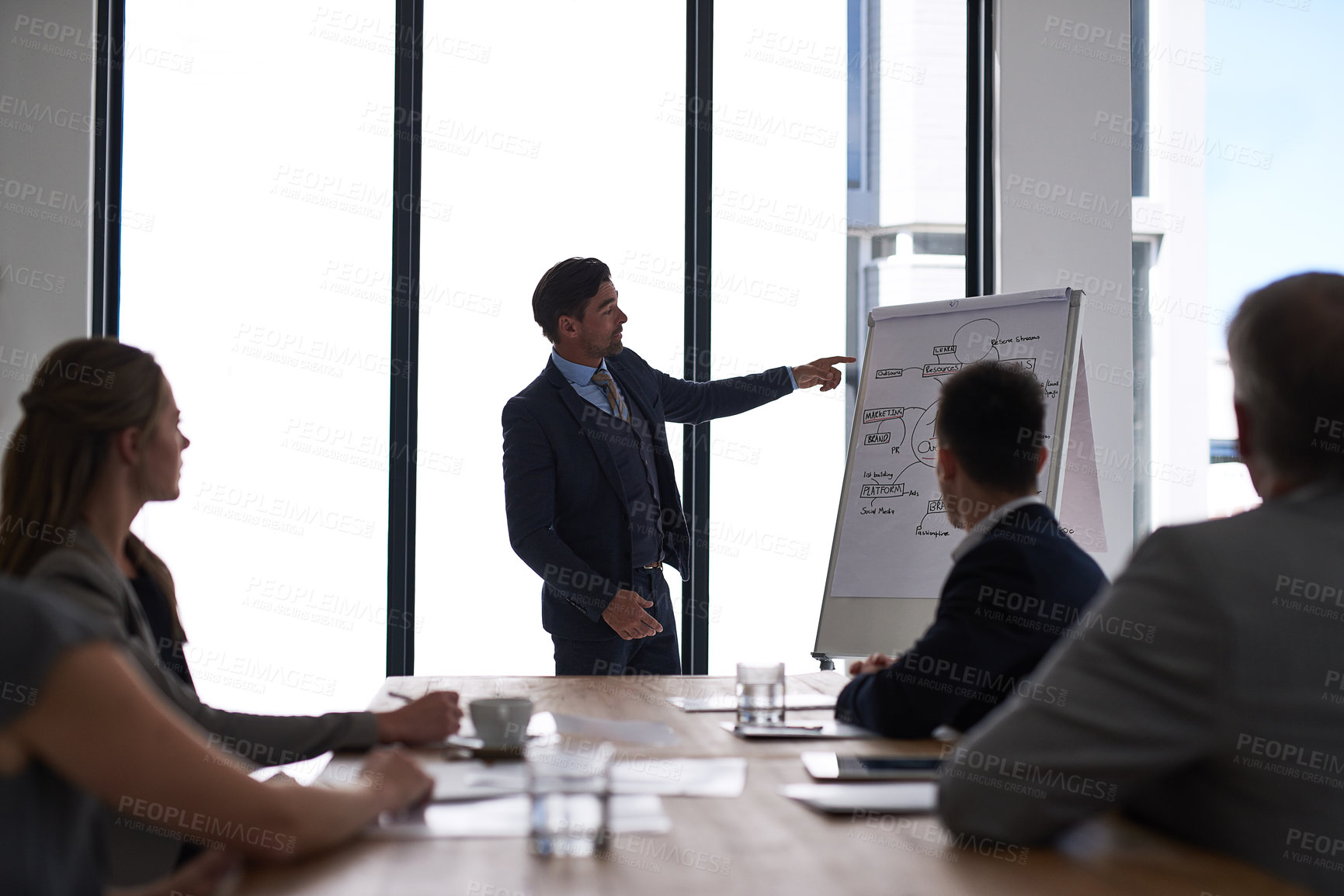 Buy stock photo Cropped shot of a businessman giving a presentation to his colleagues in a boardroom