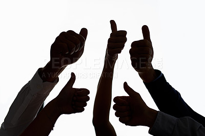 Buy stock photo Cropped shot of a group of people showing thumbs up against a white background