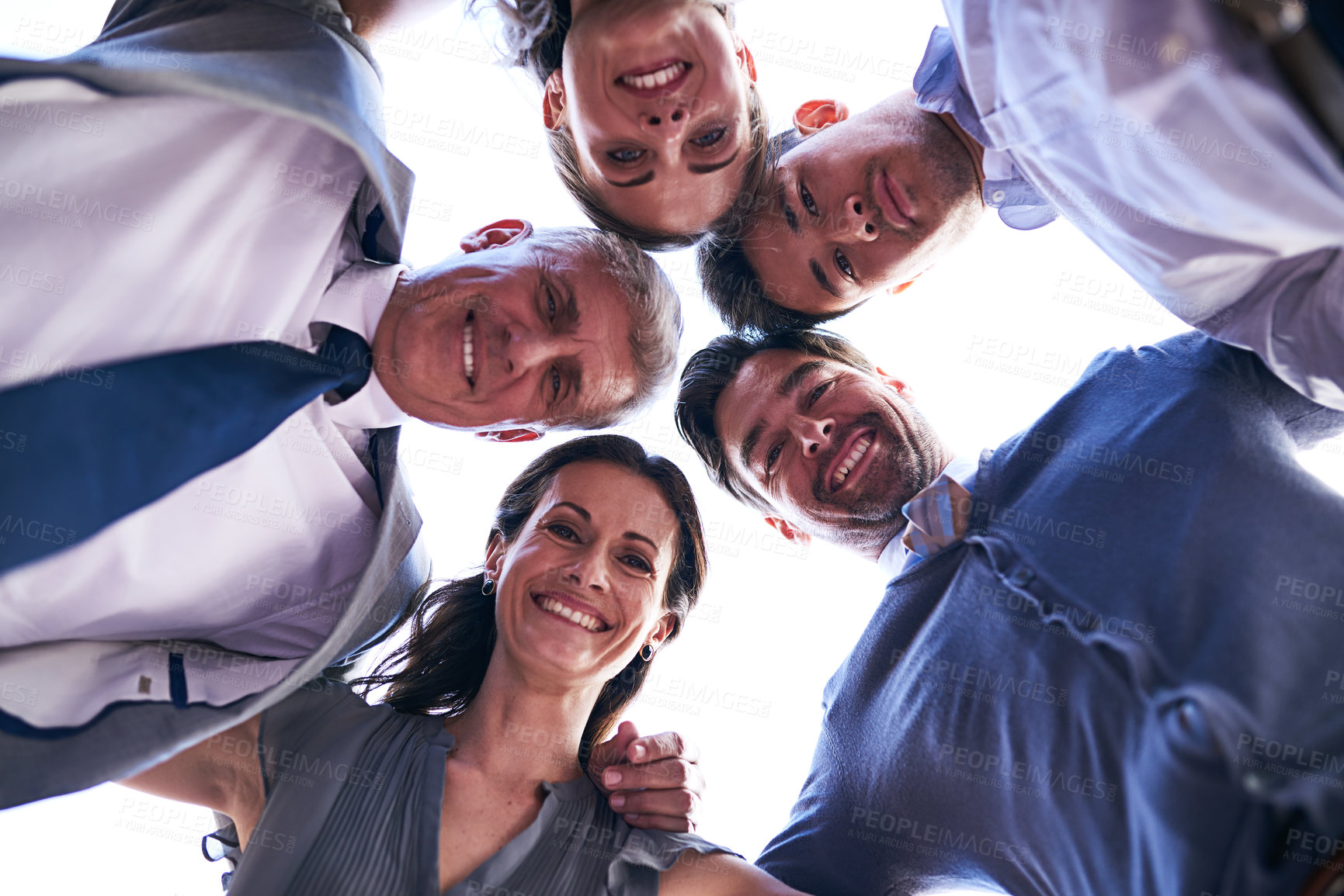 Buy stock photo Portrait of a group of businesspeople putting their heads together in a huddle