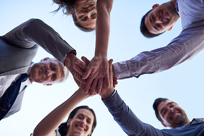 Buy stock photo Portrait of a group of businesspeople joining their hands together in unity