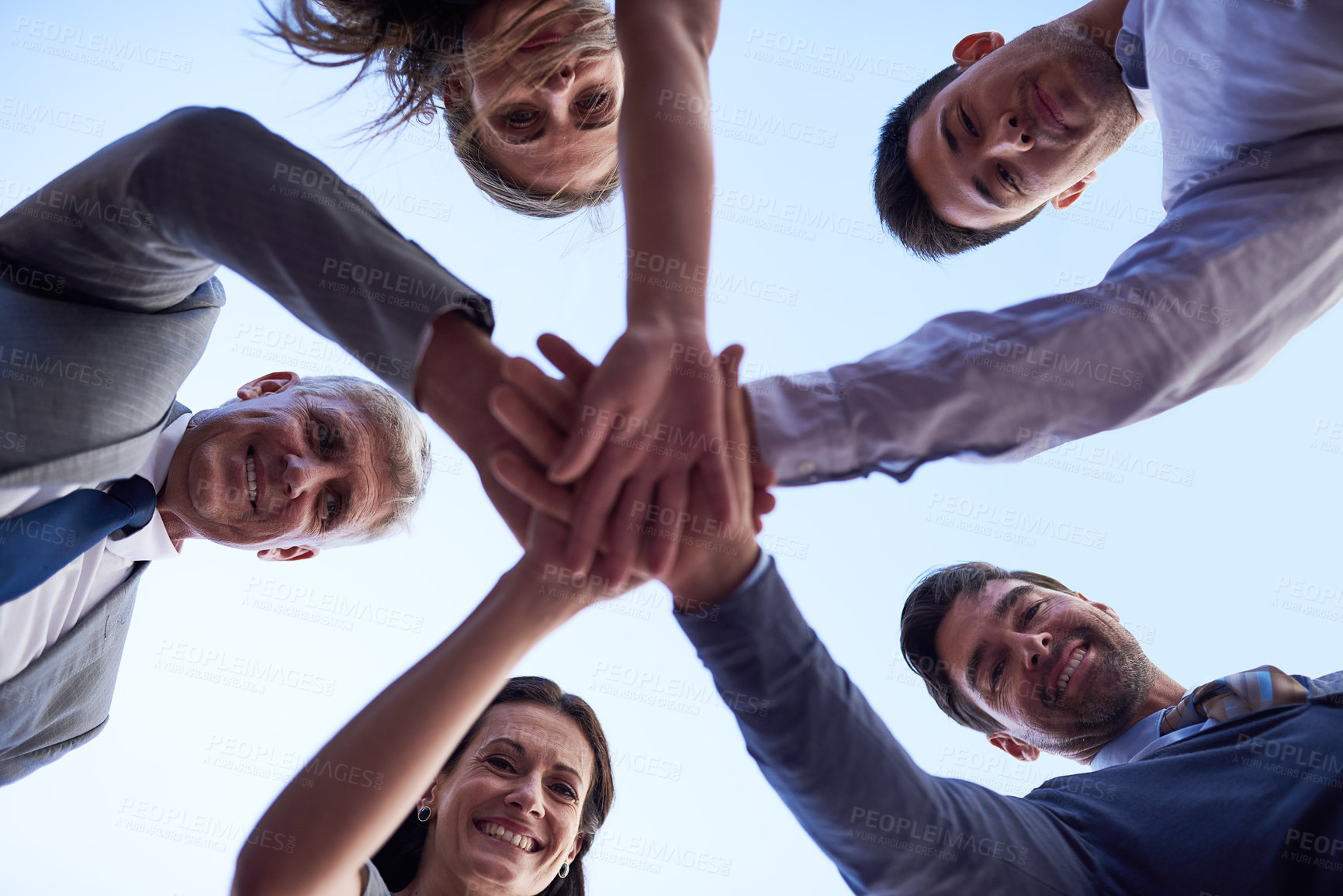 Buy stock photo Portrait of a group of businesspeople joining their hands together in unity