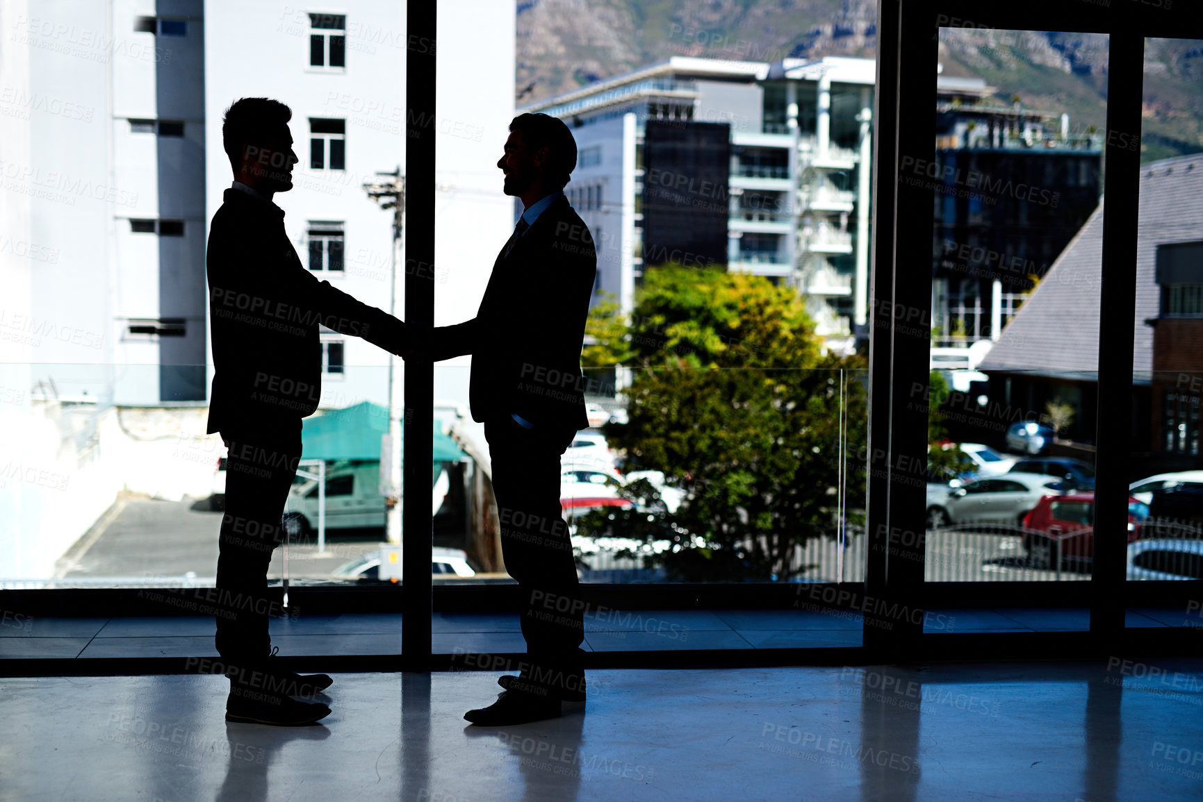 Buy stock photo Shot of two businessmen shaking hands in an office