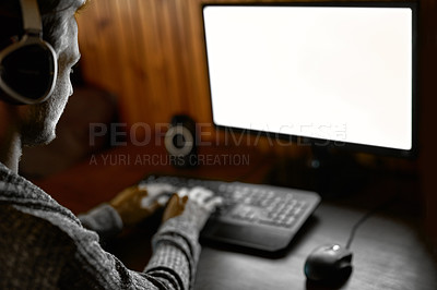 Buy stock photo Cropped shot of a young man using a computer at home