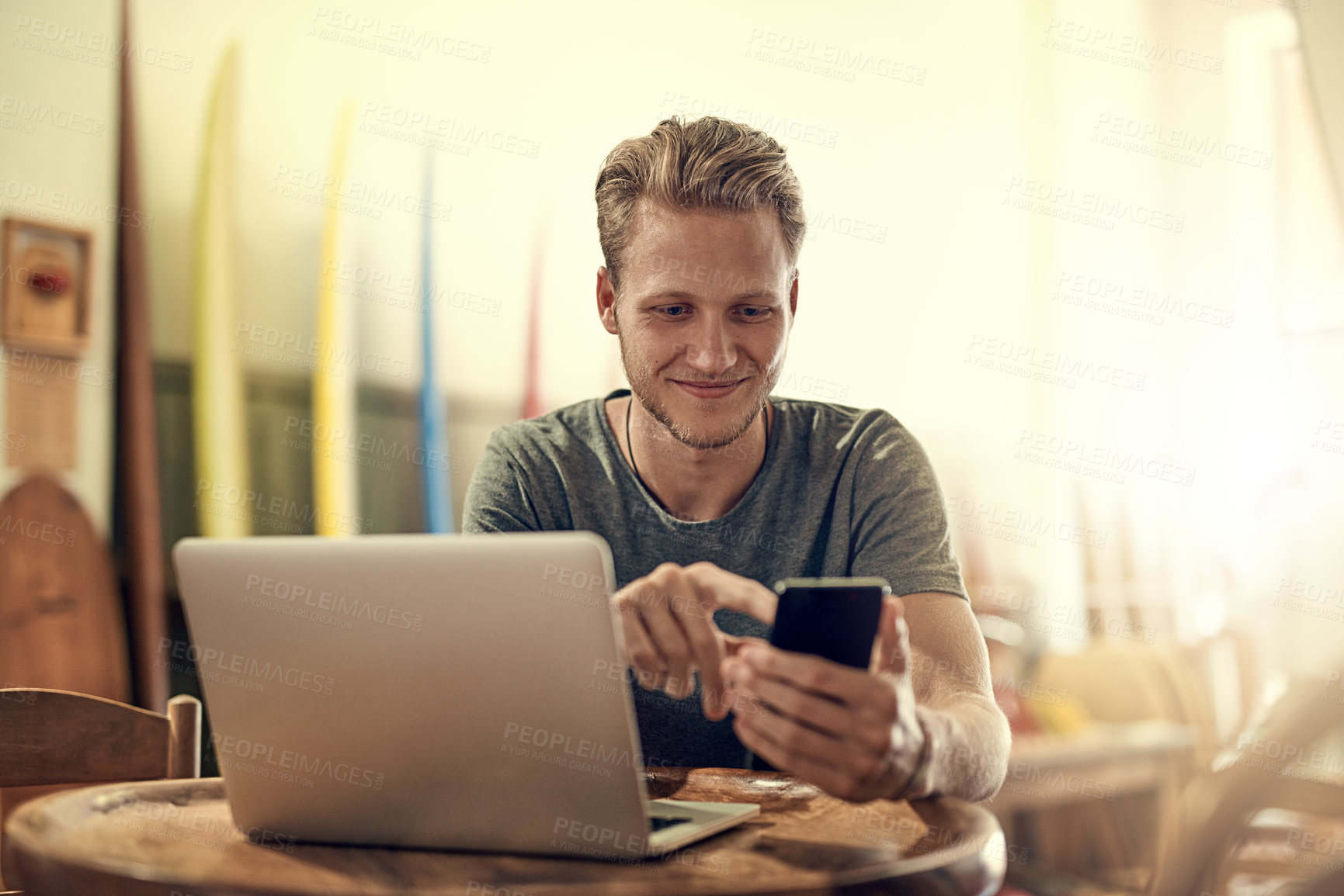 Buy stock photo Happy man, cellphone and laptop in home for social media, research and notification or update. University student, smile and technology in apartment for online and live streaming for surf report 