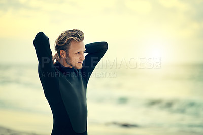 Buy stock photo Cropped shot of a young man carrying his surfboard on the beach