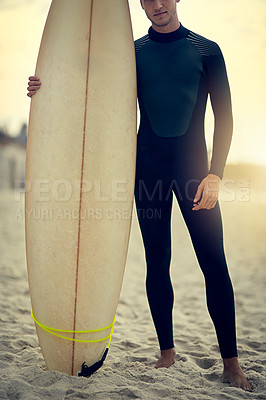 Buy stock photo Shot of an unidentifiable young surfer posing on the beach with his surfboard