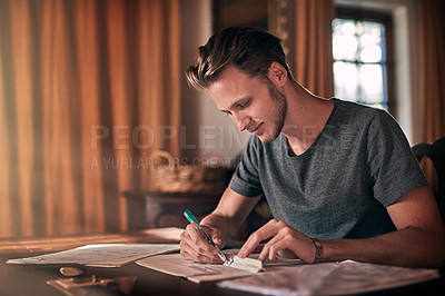 Buy stock photo Shot of a diligent young student doing a homework assignment at home