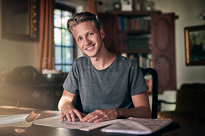 Buy stock photo Portrait of a diligent young student doing a homework assignment at home