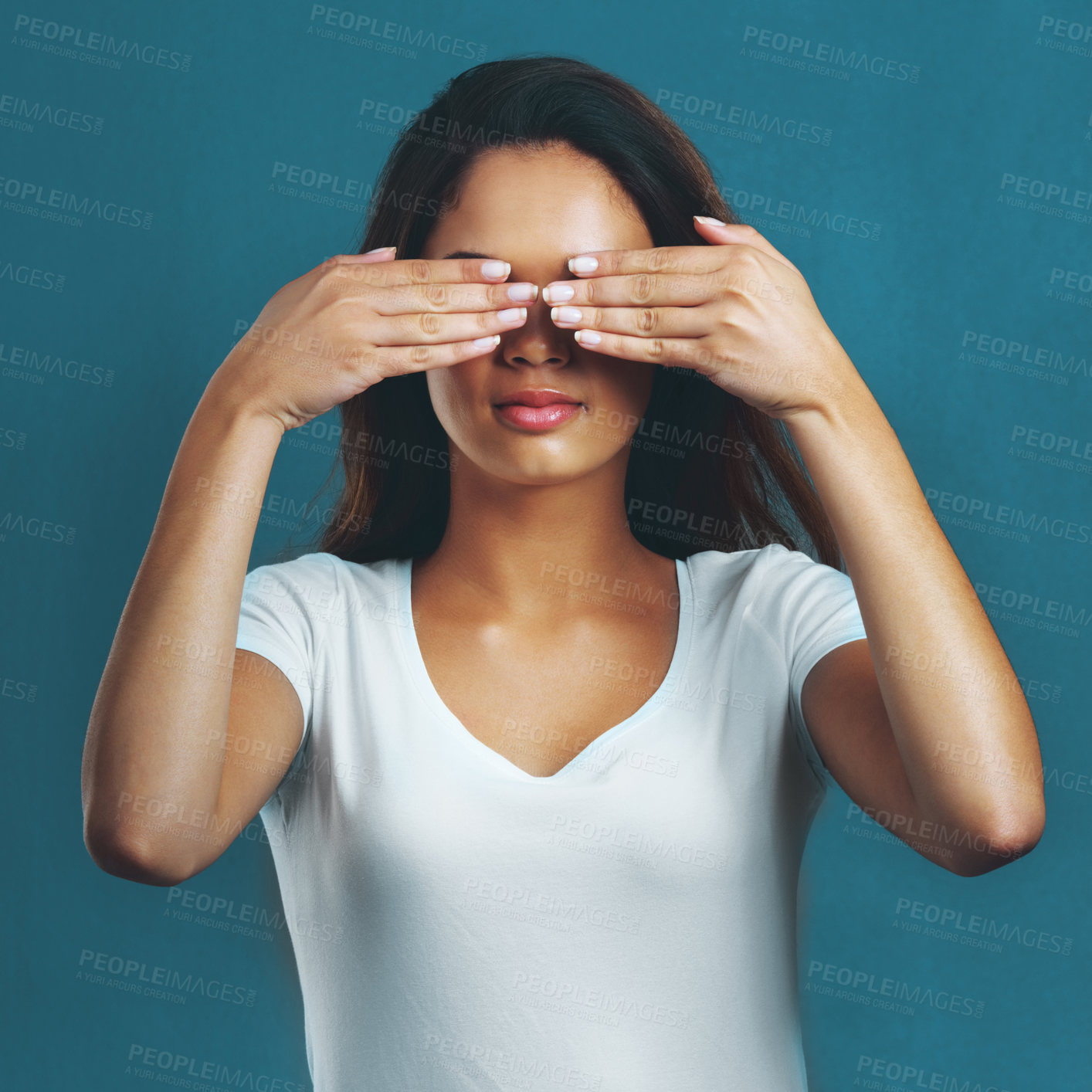 Buy stock photo Woman, studio and hands cover eyes for mental health with anxiety, horror and scared for danger. Female person, face and hiding emoji for fear, feeling embarrassed and insecurity by blue background