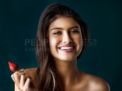 Buy stock photo Smile, portrait and woman with strawberry in studio for healthy eating, nutrition and diet balance of wellness. Happy, girl and fruit for breakfast, vitamin c and weight loss  on dark background