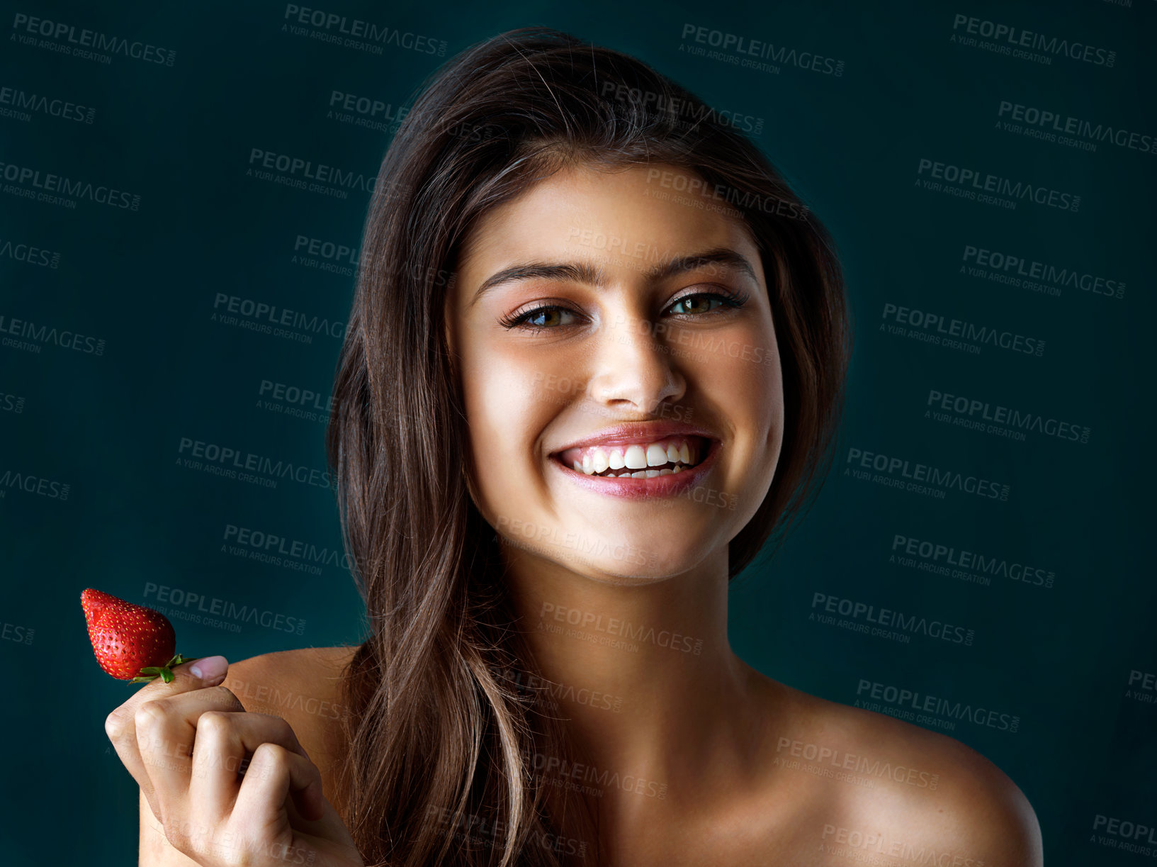 Buy stock photo Smile, portrait and woman with strawberry in studio for healthy eating, nutrition and diet balance of wellness. Happy, girl and fruit for breakfast, vitamin c and weight loss  on dark background