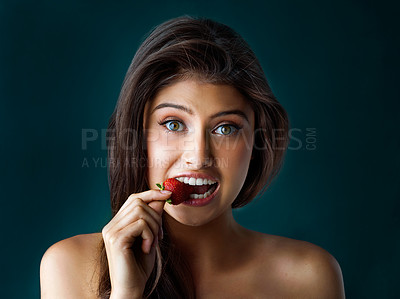 Buy stock photo Beauty, bite or portrait and woman with strawberry in studio on dark background for detox, diet or nutrition. Face, food and wellness with model eat fresh fruit for losing weight or natural vitamins