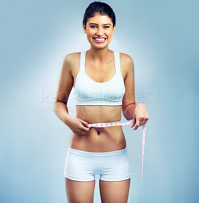 Buy stock photo Portrait, stomach and happy woman with tape measure for weight loss, body goals or fitness in studio background. Health, wellness and tummy tuck progress for self care, liposuction results or workout