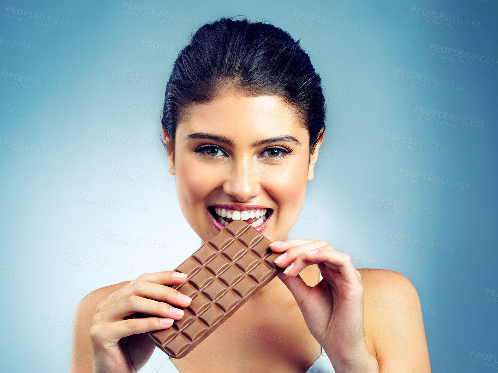 Buy stock photo Woman, portrait and happy snack and chocolate for treat or  isolated person on blue background. Smile, face and candy enjoyment, beauty with female model in studio and tasting dessert for sweets