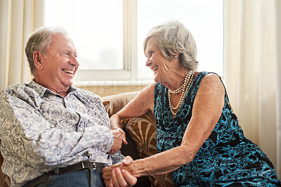 Buy stock photo Shot of a happy senior couple relaxing on the sofa together at home