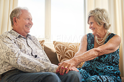 Buy stock photo Holding hands, love and smile with senior couple on sofa in living room of retirement home together for romance. Commitment, marriage or relax with elderly man and woman in apartment for bonding