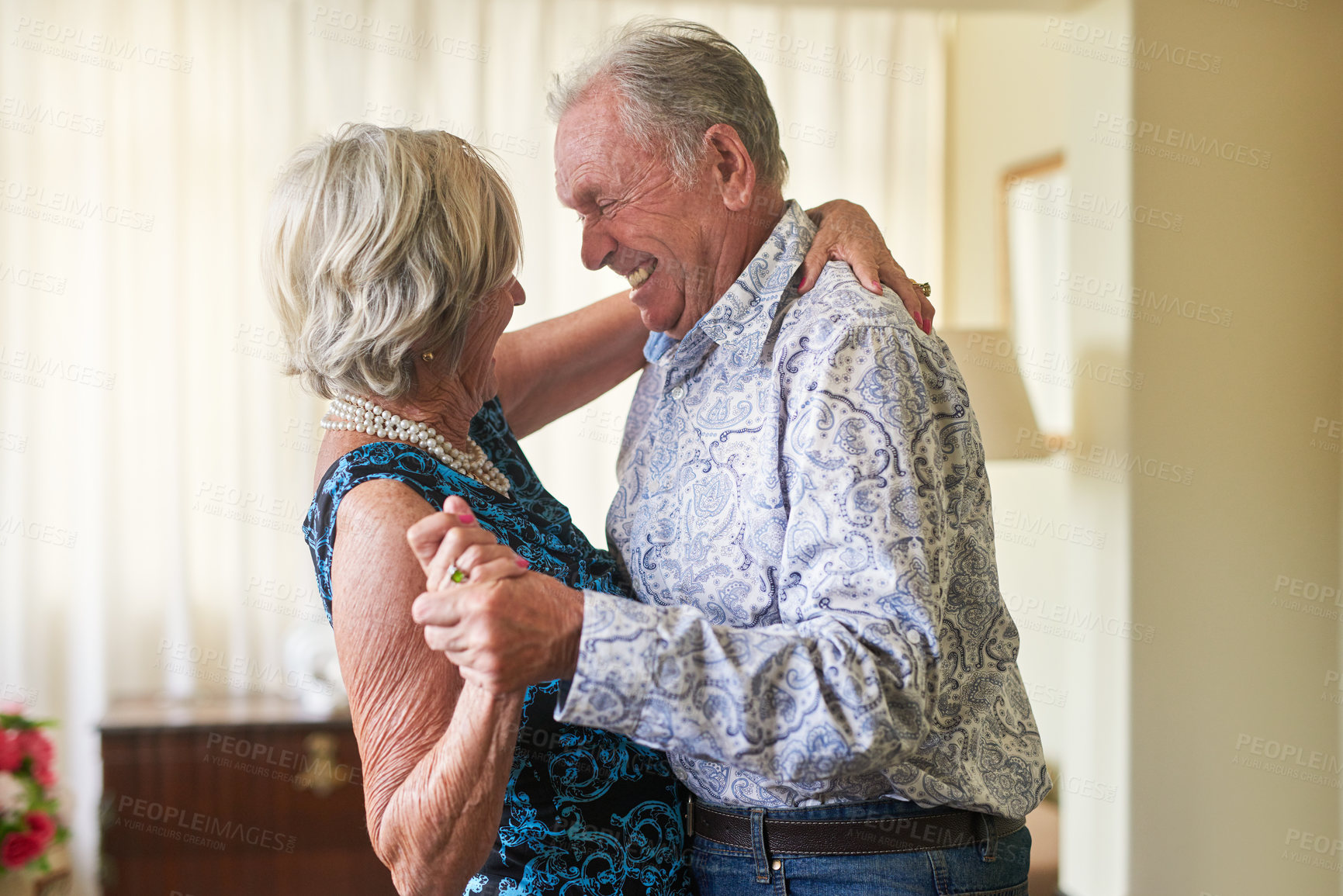 Buy stock photo Shot of a happy senior couple dancing together at home