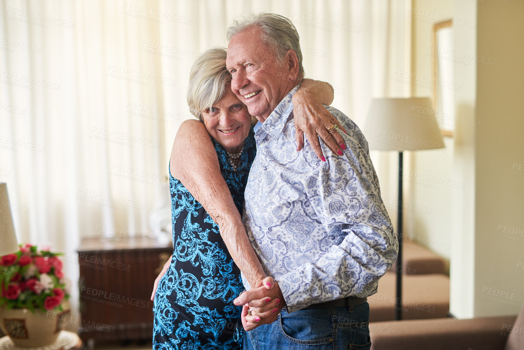 Buy stock photo Dance, love and smile with elderly couple in living room of retirement home for bonding or security. Anniversary, fun or music with senior man and woman in apartment together for safety or trust