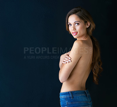Buy stock photo Shot of a beautiful young woman posing topless while covering her breast