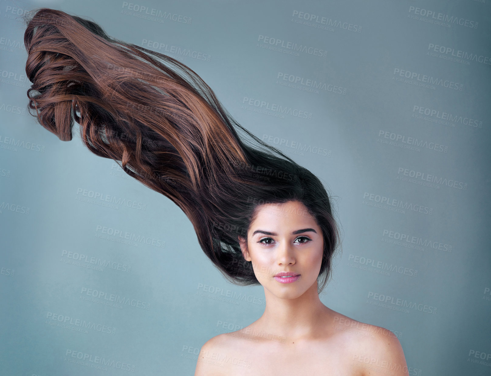 Buy stock photo Woman, studio or portrait with movement in hair care and makeup, aesthetics with facial glow. Female person, beauty transformation or cosmetics with blue background and mockup, highlights with wave