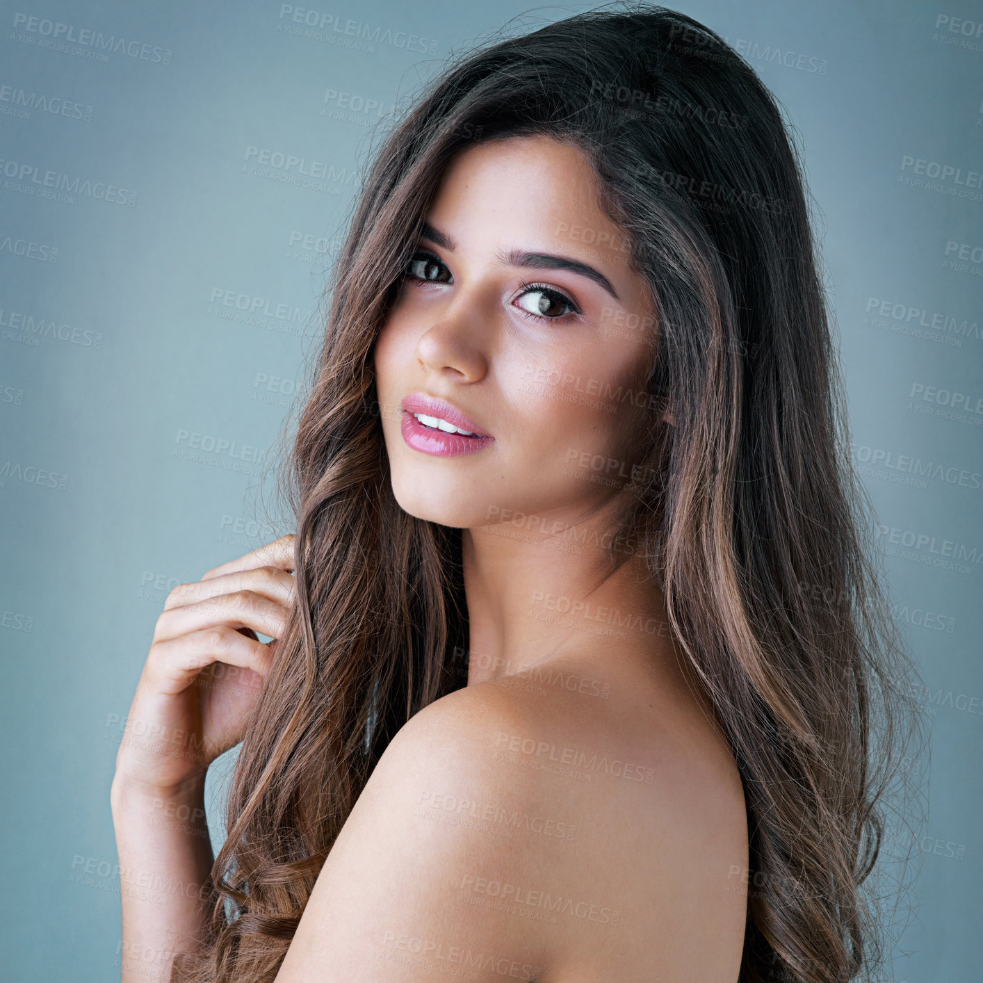 Buy stock photo Studio shot of a beautiful young woman posing against a gray background