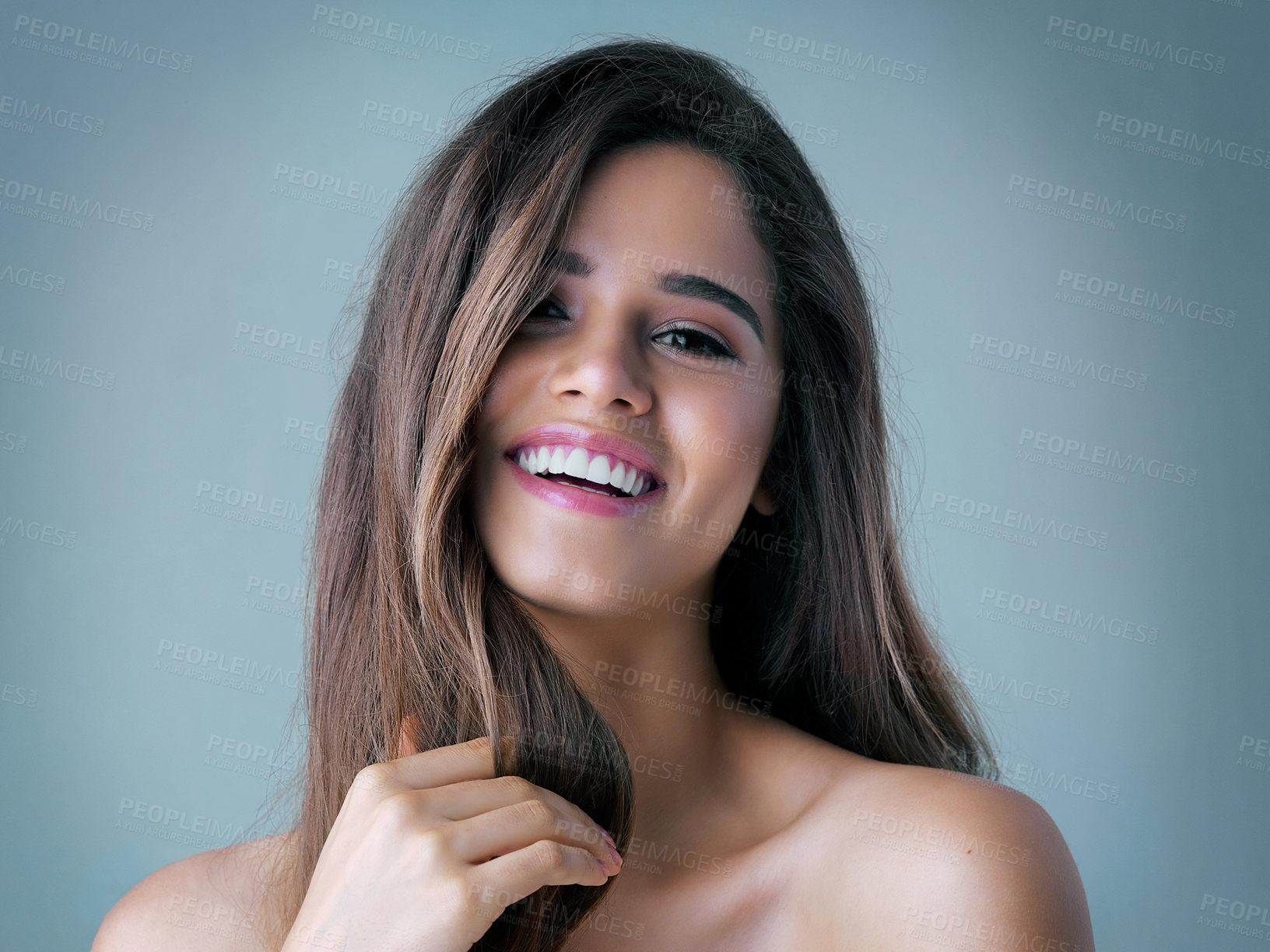 Buy stock photo Happy woman, portrait and beauty with makeup in haircare, cosmetics or skincare on a blue studio background. Attractive, young female person or model with smile for facial, cosmetology or dermatology