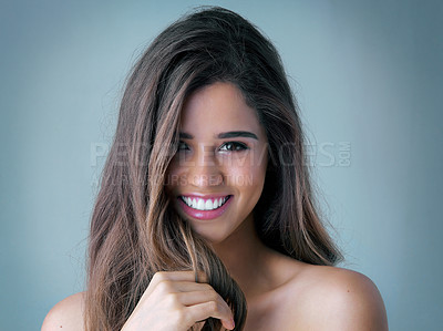 Buy stock photo Happy woman, portrait and makeup with cosmetics, haircare or skincare on a blue studio background. Attractive, young female person or model with smile for facial beauty, cosmetology or dermatology