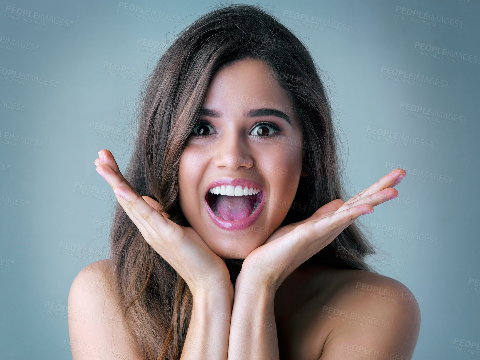 Buy stock photo Happy woman, portrait and beauty with surprise for makeup, offer or crazy deal on a blue studio background. Excited, attractive female person or young model with cosmetics in wow for glow up or shine