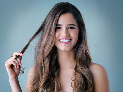 Buy stock photo Happy woman, portrait and hair with makeup for cosmetics, salon treatment or spa on a blue studio background. Attractive, young female person or model with smile for satisfaction, haircare or beauty