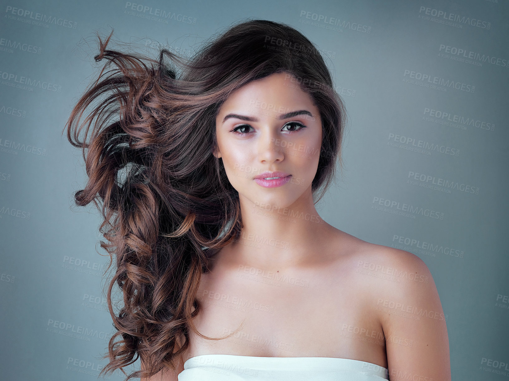 Buy stock photo Studio shot of a beautiful young woman posing against a gray background