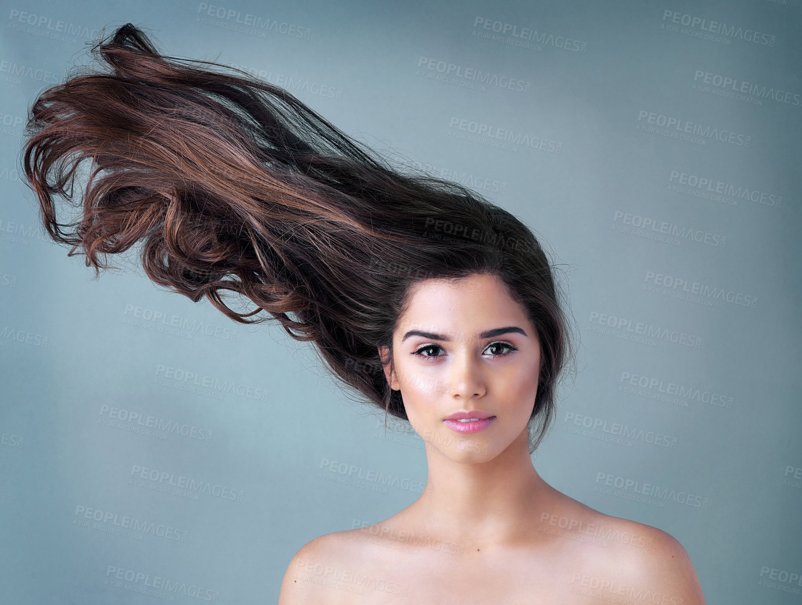 Buy stock photo Woman, blue background or portrait with wave in hair care and makeup, aesthetics with facial glow. Female person, beauty transformation or cosmetics in studio and mockup, highlights with wind