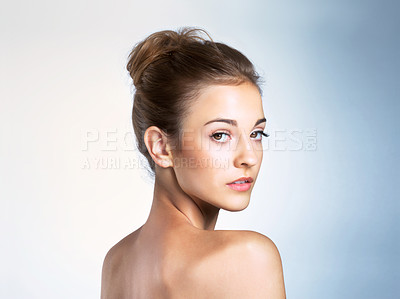 Buy stock photo Studio portrait of a beautiful young woman looking over shoulder