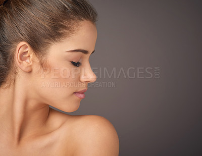 Buy stock photo Studio shot of a beautiful young woman with flawless skin posing against a gray background