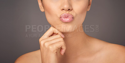 Buy stock photo Closeup studio shot of a woman with gorgeous glossy lips against a gray background