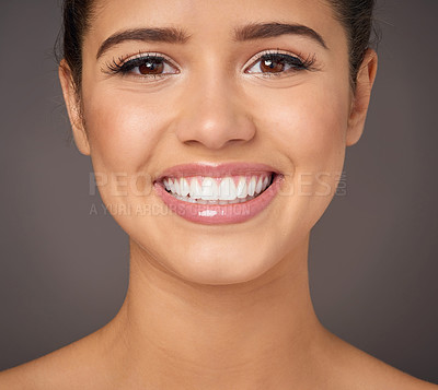 Buy stock photo Studio portrait of a beautiful young woman with flawless skin posing against a gray background