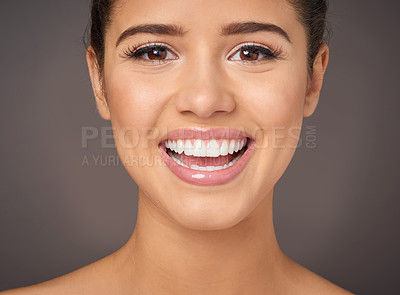Buy stock photo Studio portrait of a beautiful young woman with flawless skin posing against a gray background