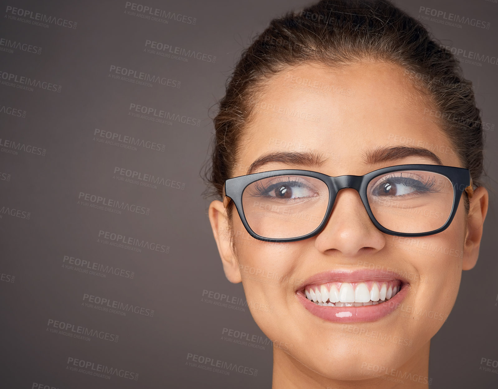 Buy stock photo Studio shot of a beautiful young woman wearing glasses against a gray background