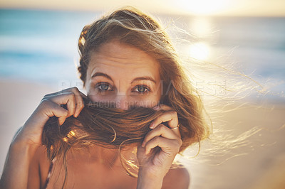 Buy stock photo Cropped shot of a young woman covering her mouth with her hair
