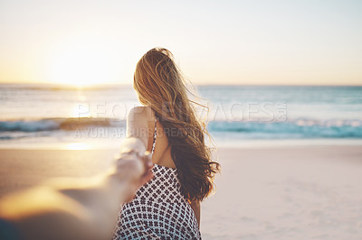 Buy stock photo Cropped shot of a young woman pulling someone's hand at the beach