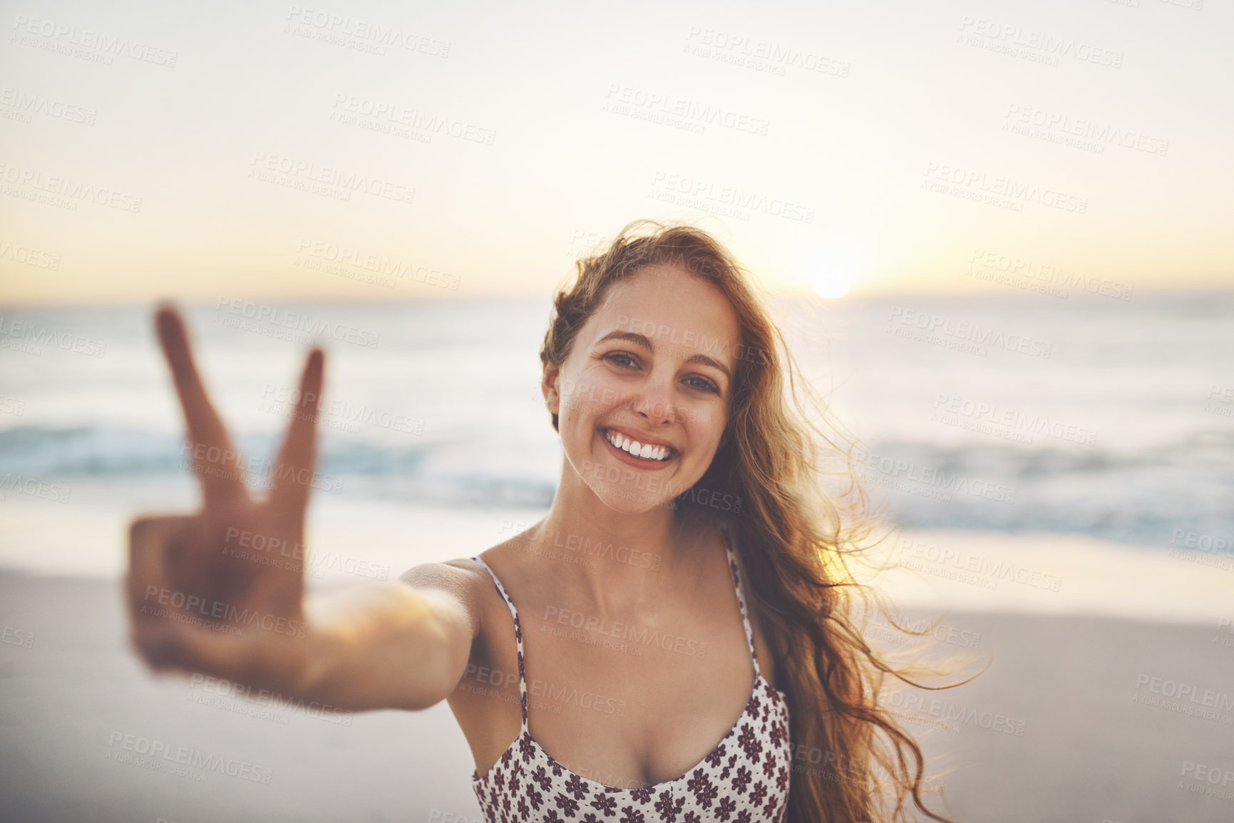 Buy stock photo Woman, portrait and peace sign at beach with smile, relax and outdoor with v emoji, review and winning by sea. Girl, happy and vacation with icon for choice, like and feedback for location at sunset